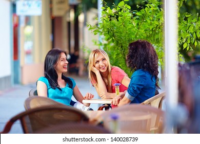 happy friends talking in summer cafe, urban outdoors