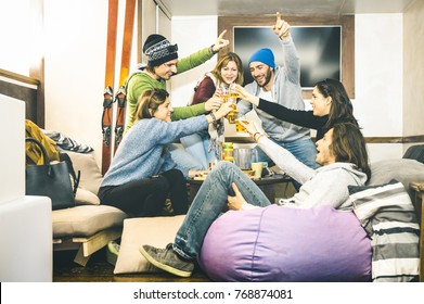 Happy Friends Toasting And Drinking Beer At After Ski Pub Lodge - Friendship Concept With Cheerful People Having Fun At Bar Restaurant Resort With Snow Equipment - Winter Season Travel Experience