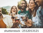 Happy friends toasting red wine glasses outside - Group of young people having bbq dinner party in backyard house - Winery and bbq dining concept with guys and girls cheering alcohol together