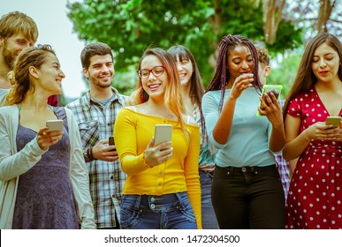 Happy friends using smartphones - Young students people having fun with technology. Friendship and university concept - Image - Shutterstock ID 1472304500