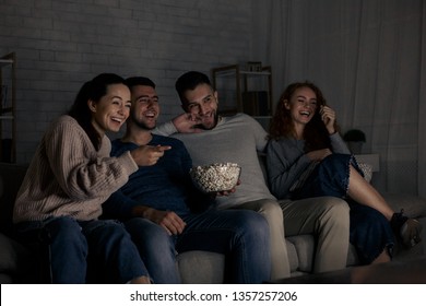 Happy Friends Watching Comedy Film And Laughing, Relaxing At Home Together