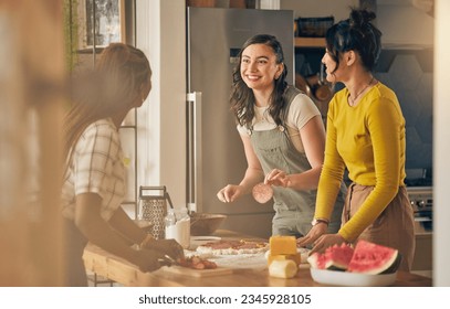 Happy, friends and women cooking pizza in kitchen, bonding and having fun together in home. Smile, girls and baking food, margherita and salami bread at lunch, cheese on meat and watermelon at brunch - Powered by Shutterstock