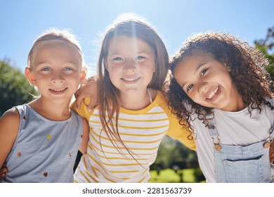 Happy, friendship and portrait of children in a park playing together outdoor in nature. Happiness, diversity and girl kid friends with smile standing, embracing and bonding in a outside green garden - Powered by Shutterstock