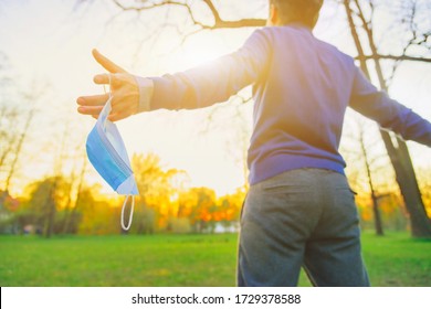 Happy fun man open hand arms take off face mask, put back. Covid 19 sick stop, lockdown end after ill. New normal safe life escape step, sun sky city fresh air breath joy, god love faith pray concept. - Shutterstock ID 1729378588