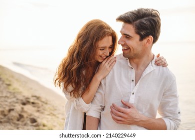Happy fun young couple two friends family man woman in casual clothes hug girlfriend put head on boyfriend shoulder at sunrise over sea beach ocean outdoor exotic seaside in summer day sunset evening - Shutterstock ID 2140229449