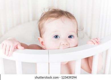 Happy Funny Baby Biting On Its Crib