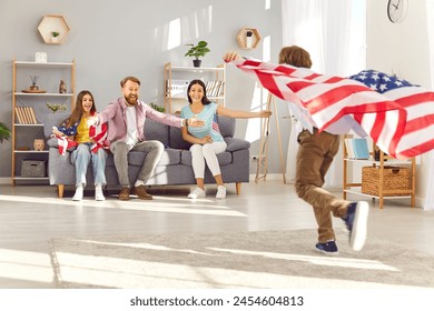 Happy funny children having fun and running with flags of united states in living room at home celebrating Independence Day with parents. Family patriotism and US patriotic holiday concept. - Powered by Shutterstock