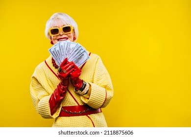Happy and funny cool old lady with fashionable clothes portrait on colored background - Youthful grandmother with extravagant style, concepts about lifestyle, seniority and elderly people - Shutterstock ID 2118875606