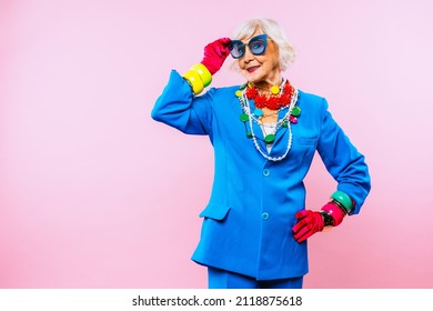 Happy and funny cool old lady with fashionable clothes portrait on colored background - Youthful grandmother with extravagant style, concepts about lifestyle, seniority and elderly people - Shutterstock ID 2118875618