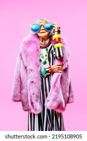 Happy and funny cool old lady with fashionable clothes portrait on colored background - Youthful grandmother with extravagant style, concepts about lifestyle, seniority and elderly people - Shutterstock ID 2195108905