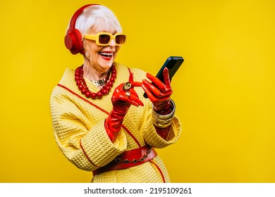 Happy and funny cool old lady with fashionable clothes portrait on colored background - Youthful grandmother with extravagant style, concepts about lifestyle, seniority and elderly people - Shutterstock ID 2195109261