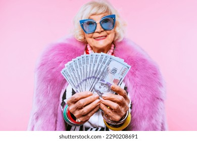 Happy and funny cool old lady with fashionable clothes portrait on colored background - Youthful grandmother with extravagant style, concepts about lifestyle, seniority and elderly people - Shutterstock ID 2290208691