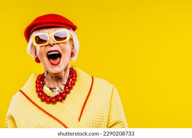 Happy and funny cool old lady with fashionable clothes portrait on colored background - Youthful grandmother with extravagant style, concepts about lifestyle, seniority and elderly people - Shutterstock ID 2290208733