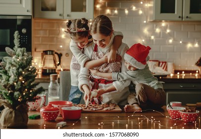 happy funny family mother and children  bake christmas cookies - Powered by Shutterstock