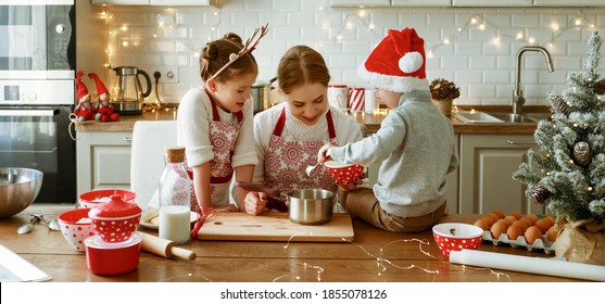 Happy Funny Family Mother And Children  Bake Christmas Cookies On Cozy Kitchen At Home
