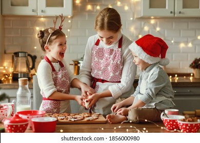 Happy Funny Family Mother And Children  Bake Christmas Cookies On Cozy Kitchen At Home
