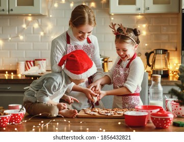 happy funny family mother and children  bake christmas cookies on cozy kitchen at home