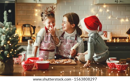 happy funny family mother and children  bake christmas cookies
