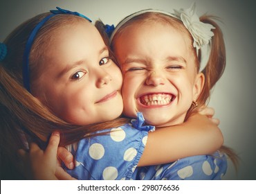 Happy Funny Girl Twins Sisters Hugging And Laughing