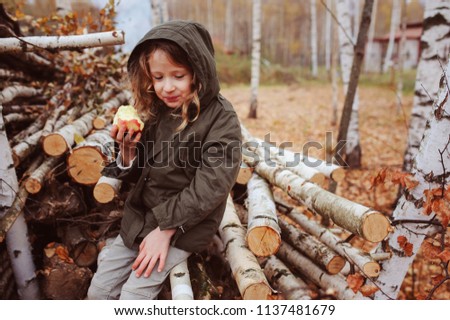 Image, Stock Photo happy funny kid girl eating fresh apple in autumn