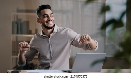 Happy Funny Male Arabic Businessman Hispanic Young Guy Millennial Smiling Man Active Dancing At Home Office Has Fun Celebrate End Of Working Enjoy Exercises Movement Sing Favorite Song Take Job Pause