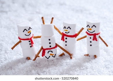 Happy funny marshmallow snowmans are having fun in snow - Powered by Shutterstock