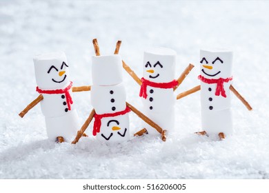 Happy Funny Marshmallow Snowmen Are Having Fun In Snow