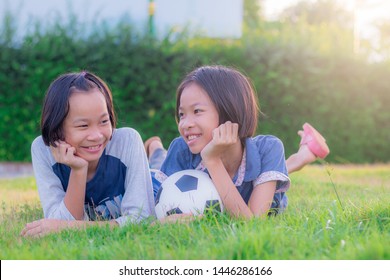 Happy Funny Sisters Twins Child Playing. Asian Little Girl In Park At Thailand