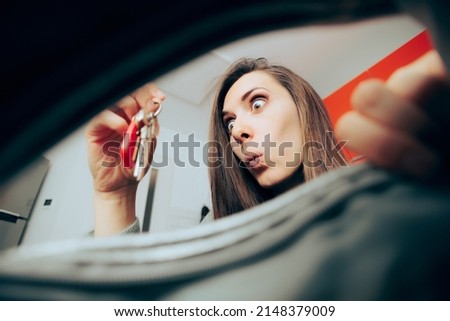 
Happy Funny Woman Fining Her Keys in Messy Purse. Scatterbrain person searching for car key in her handbag 
