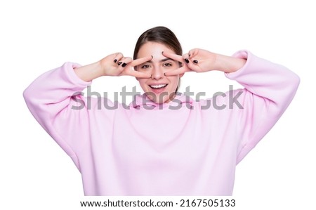 happy funny young girl in pink hoodie isolated on white background. peace