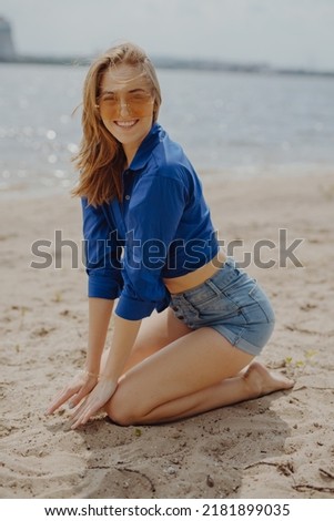 Similar – Young woman sits at the Baltic Sea beach