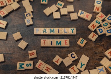 Happy Game Night. Leisure Activities Concept. Colourful Square Wooden Letters On A Dark Wooden Table Creating The Words FAMILY TIME. High Quality Photo