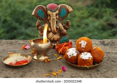 happy ganesh chaturthi, Ganesha with sweet moti choor laddu, Worship material, focus on a ganesha, landscape image,