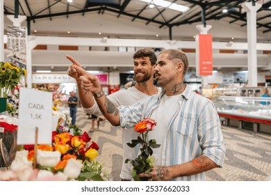 Happy gay couple choosing roses in a flower shop at a bustling market hall, enjoying shopping together surrounded by colorful blooms. Located in lisbon, portugal - Powered by Shutterstock