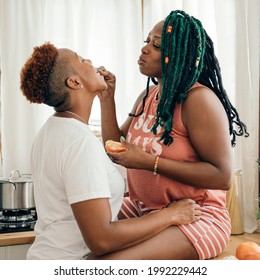 Happy Gay Couple Eating In The Kitchen