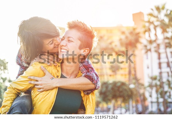Happy gay\
couple having fun together outdoor - Young millennials women having\
a date - Equality right, homosexuality lifestyle, lgbt, and\
relationship concept - Focus on right girl\
face