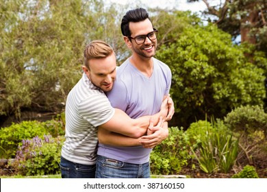 Happy Gay Couple Hugging In Garden