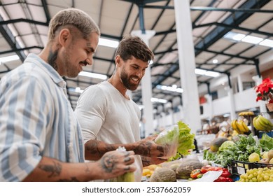 Happy gay couple joyfully selecting fresh lettuce at the farmer's market, showcasing their love and commitment to a healthy lifestyle - Powered by Shutterstock