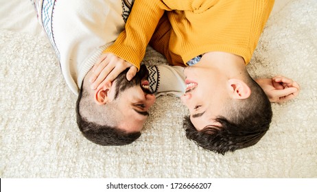 Happy Gay Couple In Love Looking At Each Other In Bed