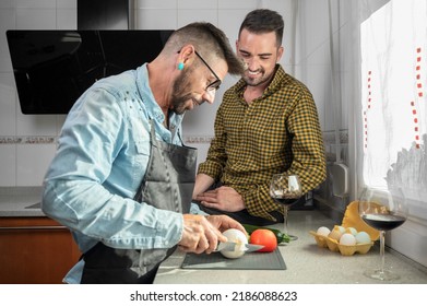 Happy Gay Couple In Love Standing In The Kitchen. They Are Cooking Dinner Together At Home. High Quality Photography