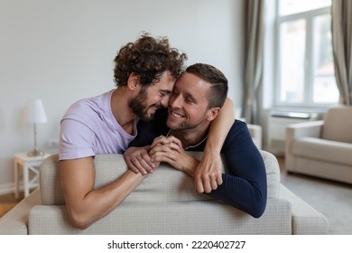 Happy Gay Couple Lying Down On The Bed At Home, Hugging And Flirting. LGBT Gay Couple Love Moments Happiness Concept