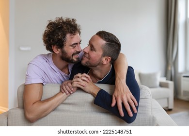 Happy Gay Couple Lying Down On The Bed At Home, Hugging And Flirting. LGBT Gay Couple Love Moments Happiness Concept