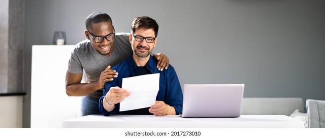 Happy Gay Couple Reading Letter Or Mail