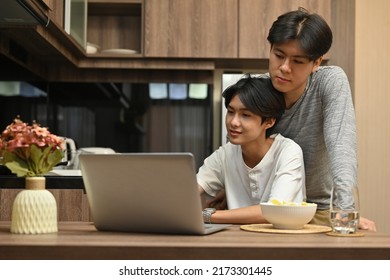 Happy Gay Couple Spending The Day Together With The Movie On The Laptop, Gay Couples And Everyday Life At Home Concept.