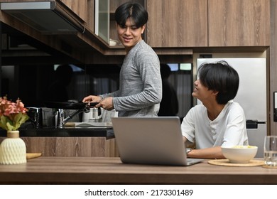 A Happy Of Gay Couple Spending The Day Together At Home While His Boyfriends Cooking In The Kitchen, Gay Couples And Everyday Life At Home Concept.