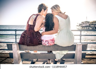 happy gay couple spending time together with their adopted daughter - Powered by Shutterstock