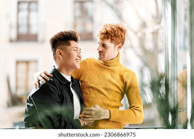 Happy gay couple in the terrace at home - Powered by Shutterstock