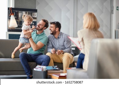 Happy Gay Fathers Enjoying In Shopping And Having Fun With Child Girl.