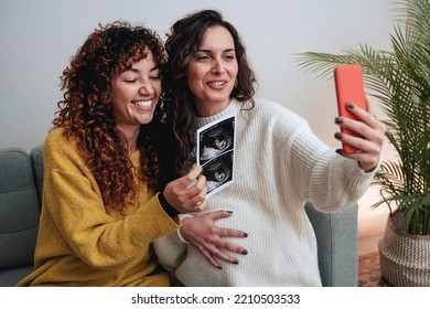 Happy Gay Lesbian Couple Holding Ultrasound Photo Scan On Video Call - Growing Baby In Pregnancy Time Concept.