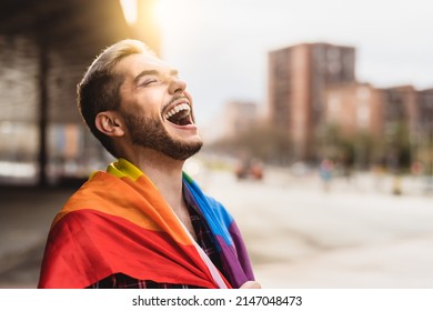 Happy Gay Man Having Fun Holding Rainbow Flag Symbol Of LGBTQ Community